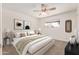 Staged bedroom featuring a ceiling fan, carpeted floor and a large bed with decorative pillows and tasteful decor at 518 N Cheri Lynn Dr, Chandler, AZ 85225