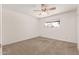 An empty bedroom features carpet, a ceiling fan, and a window providing natural light and ventilation at 518 N Cheri Lynn Dr, Chandler, AZ 85225