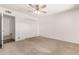 Empty bedroom featuring carpet, a ceiling fan, closet, window and neutral walls at 518 N Cheri Lynn Dr, Chandler, AZ 85225