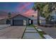 Charming home featuring modern garage door, pathway lighting, and well-manicured landscaping at 5239 E Waltann Ln, Scottsdale, AZ 85254