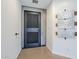 Hallway with a stylish black door, modern metal artwork, and polished concrete floors at 5239 E Waltann Ln, Scottsdale, AZ 85254