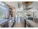 Sleek kitchen featuring stainless steel appliances, polished countertops, open shelving, and natural light at 5239 E Waltann Ln, Scottsdale, AZ 85254