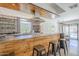 Stylish kitchen with unique wood accents, stainless steel appliances, and an adjacent dining area at 5239 E Waltann Ln, Scottsdale, AZ 85254