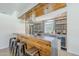 Modern kitchen featuring a unique bar and wood-slat ceiling, offering a modern industrial design at 5239 E Waltann Ln, Scottsdale, AZ 85254