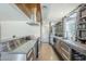 Sleek kitchen featuring stainless steel appliances, polished countertops, open shelving, and natural light at 5239 E Waltann Ln, Scottsdale, AZ 85254