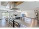 Open kitchen and living room area with stainless appliances, island seating, and seamless entertaining space at 5239 E Waltann Ln, Scottsdale, AZ 85254