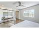 Bright main bedroom with polished floors, large mirror closet doors, and a ceiling fan at 5239 E Waltann Ln, Scottsdale, AZ 85254