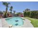 Backyard swimming pool with surrounding landscaping featuring palm trees, putting green, and flowering shrubs at 5239 E Waltann Ln, Scottsdale, AZ 85254