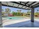 Backyard pool area featuring a covered patio, pool, putting green, privacy hedges, and an outdoor seating area at 5239 E Waltann Ln, Scottsdale, AZ 85254