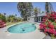 This outdoor pool and patio area feature a seating area, turf, and beautiful landscaping at 5239 E Waltann Ln, Scottsdale, AZ 85254