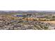 Expansive aerial view highlights residential community against a desert landscape, mountains, and the city skyline at 5954 E Cat Balue Dr, Phoenix, AZ 85054