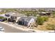 Aerial view of a modern desert home featuring drought-resistant landscaping, a gray roof, and an attached garage at 5954 E Cat Balue Dr, Phoenix, AZ 85054