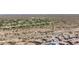 An aerial view captures a new construction community near a golf course and desert landscape at 5954 E Cat Balue Dr, Phoenix, AZ 85054