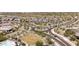 An aerial view showcases the neighborhood's modern homes and roundabout entry at 5954 E Cat Balue Dr, Phoenix, AZ 85054