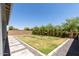 Well-maintained backyard with lush green grass, manicured shrubbery, and a decorative stone border at 5954 E Cat Balue Dr, Phoenix, AZ 85054
