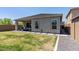 Spacious backyard featuring a covered patio, well-kept lawn, and pathway at 5954 E Cat Balue Dr, Phoenix, AZ 85054