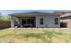Charming backyard featuring a covered patio, green lawn, and stone walkway at 5954 E Cat Balue Dr, Phoenix, AZ 85054