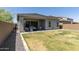 Well-maintained backyard with covered patio, lush lawn, and manicured landscaping at 5954 E Cat Balue Dr, Phoenix, AZ 85054