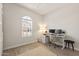 Versatile bedroom with a large window, wood-look tile, and a desk set-up, ideal for a home office at 5954 E Cat Balue Dr, Phoenix, AZ 85054