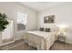 Cozy bedroom with wood-look tile flooring, neutral colors and walk-in closet, bright and airy at 5954 E Cat Balue Dr, Phoenix, AZ 85054