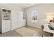 Murphy bed bedroom with built-in shelves, a window, and a desk; versatile and functional at 5954 E Cat Balue Dr, Phoenix, AZ 85054