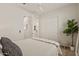 Comfortable bedroom features a ceiling fan and closet with a view to a bathroom at 5954 E Cat Balue Dr, Phoenix, AZ 85054