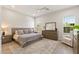 Spacious bedroom with wood-look floors, ceiling fan, and complementary furnishings at 5954 E Cat Balue Dr, Phoenix, AZ 85054