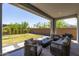 Inviting covered patio with comfortable seating, a grill, and views of the green backyard at 5954 E Cat Balue Dr, Phoenix, AZ 85054