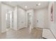 Open entryway featuring light wood-look floors, neutral walls, and ample closet space at 5954 E Cat Balue Dr, Phoenix, AZ 85054