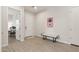 Bright entryway with decorative painting, light wood-look floors, and a comfortable bench at 5954 E Cat Balue Dr, Phoenix, AZ 85054