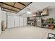 Spacious garage with epoxy flooring, organized shelving, and overhead storage racks at 5954 E Cat Balue Dr, Phoenix, AZ 85054