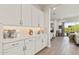 Bright kitchen boasts white cabinets, ample counter space, and tile backsplash, perfect for cooking at 5954 E Cat Balue Dr, Phoenix, AZ 85054