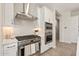 Modern kitchen with stainless steel appliances, a gas range, and white tile backsplash at 5954 E Cat Balue Dr, Phoenix, AZ 85054