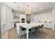 Spacious modern kitchen with stainless steel appliances, a large island, and light wood-look floors at 5954 E Cat Balue Dr, Phoenix, AZ 85054