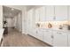 Bright kitchen featuring white cabinets, quartz countertops, tile backsplash and stainless steel hardware at 5954 E Cat Balue Dr, Phoenix, AZ 85054