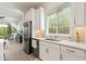 Bright kitchen featuring stainless steel appliances, light countertops, and a view into the living area at 5954 E Cat Balue Dr, Phoenix, AZ 85054