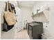 Bright laundry room with front loading washer and dryer, overhead shelf and convenient storage at 5954 E Cat Balue Dr, Phoenix, AZ 85054