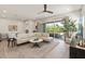 Airy living room with an elegant ceiling fan, sliding doors, and a large comfortable sofa at 5954 E Cat Balue Dr, Phoenix, AZ 85054