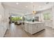 Open-concept living space with a kitchen island, stainless steel appliances, and views of the backyard at 5954 E Cat Balue Dr, Phoenix, AZ 85054