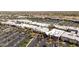 Expansive aerial view of a shopping center, showcasing multiple stores, palm trees, and extensive parking areas at 5954 E Cat Balue Dr, Phoenix, AZ 85054