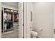 Spacious walk-in closet features custom shelving and ample storage space, adjacent half bathroom at 5954 E Cat Balue Dr, Phoenix, AZ 85054