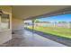 Covered back patio overlooking a spacious, grassy yard at 624 N Ashbrook Cir, Mesa, AZ 85213