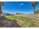 Wide backyard with a high block fence, offering privacy and space for outdoor living and recreation at 624 N Ashbrook Cir, Mesa, AZ 85213