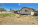 Expansive backyard with ample space for activities, complemented by a covered patio and mature trees at 624 N Ashbrook Cir, Mesa, AZ 85213