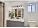 Bathroom featuring marble vanity, updated fixtures, and shelving at 624 N Ashbrook Cir, Mesa, AZ 85213