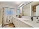 Bathroom with dual sinks, white cabinets, and modern fixtures at 624 N Ashbrook Cir, Mesa, AZ 85213