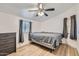 Bedroom with a simple bed, laminate flooring, and a dresser at 624 N Ashbrook Cir, Mesa, AZ 85213
