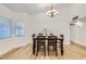 Bright dining area with a table set for four under an elegant chandelier and large window at 624 N Ashbrook Cir, Mesa, AZ 85213