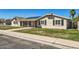 Street view of single-story home featuring solar panels and inviting covered entrance at 624 N Ashbrook Cir, Mesa, AZ 85213