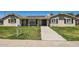 Charming single-story home with a well-manicured lawn, solar panels, and inviting front porch at 624 N Ashbrook Cir, Mesa, AZ 85213